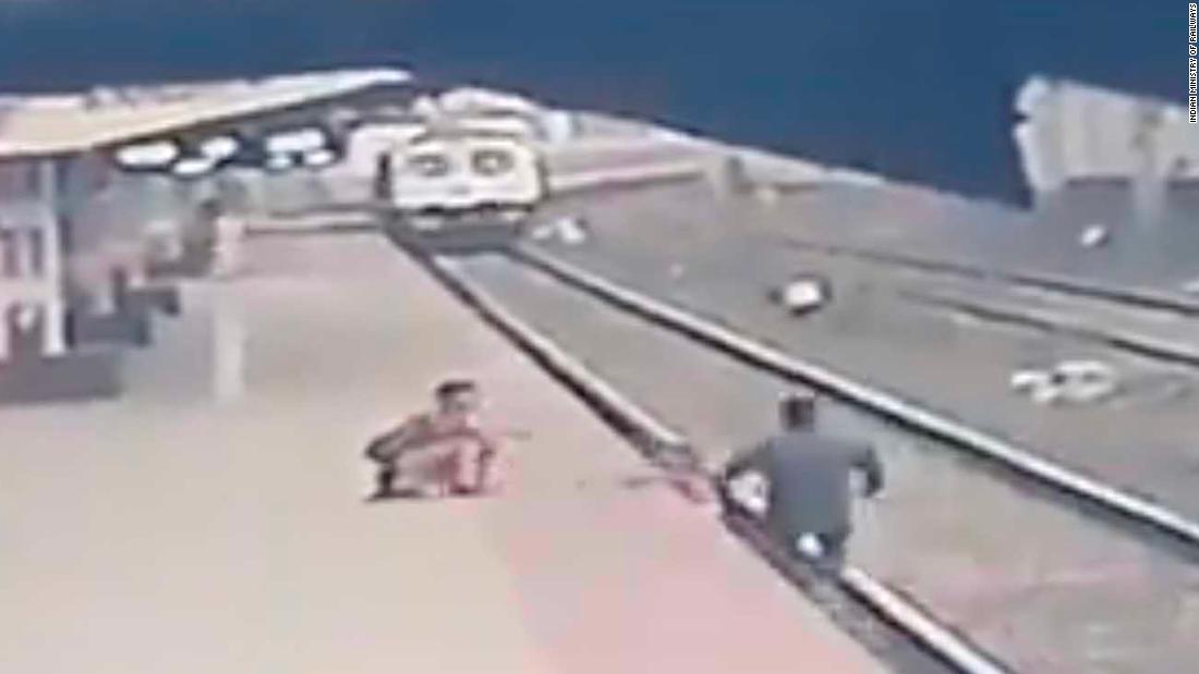 See moment child is saved from oncoming train - (Video). 49