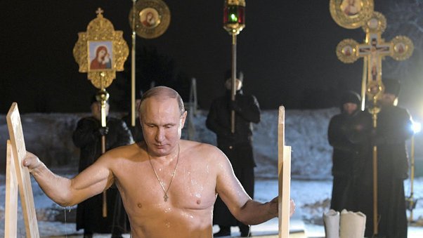Why does President Vladimir Putin wears a shiny golden crucifix hanging from his neck and on his bare chest all the time? 56