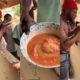 Man completing Alomo Bitters and gari mix challenge in Ghana for GHS10 reward