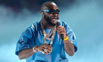 Davido performing on stage while confronting a fan holding a baby at his Abia State concert