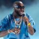 Davido performing on stage while confronting a fan holding a baby at his Abia State concert