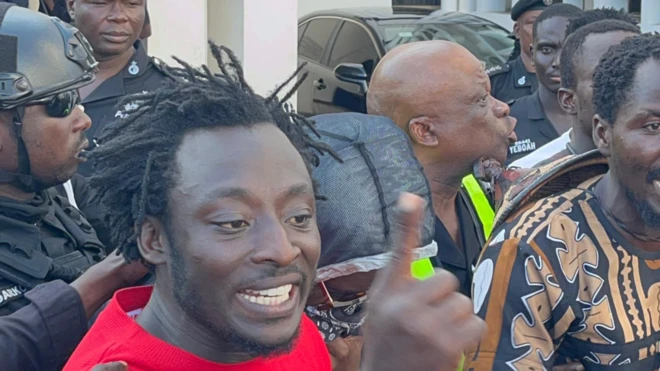 Activist Ralph De Fellow confronting water sellers on a busy Accra street over plastic littering