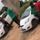 Loan collector forcibly dragging a distressed woman into a vehicle during a public altercation over unpaid debt.