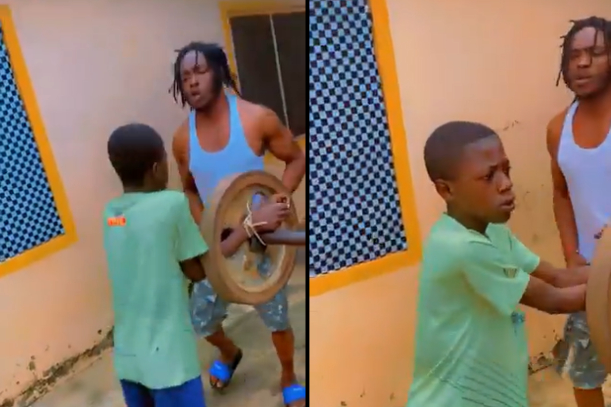 Young boy jogging with tied hands as punishment after skipping school.
