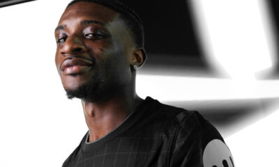 Mohammed Kudus holding Tottenham Hotspur jersey after signing