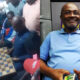 Kennedy Agyapong playing draughts with a local opponent in Ablekuma North as supporters cheer during a campaign visit for Nana Akua Owusu Afriyie.