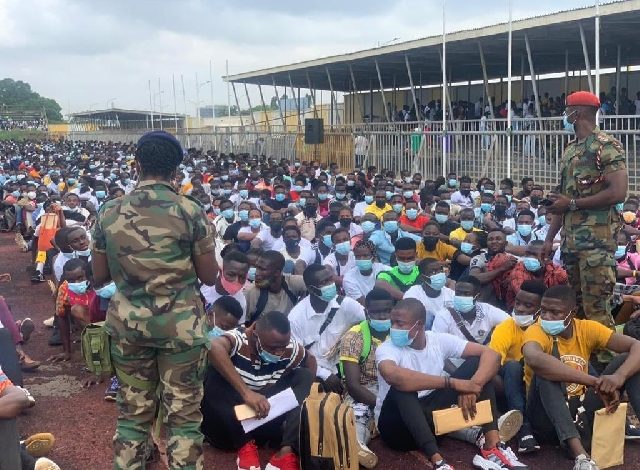 Disappointed GAF applicants holding documents in protest outside a government office after the 2021 recruitment delay.