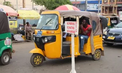 Ghanaian Pragya riders parked near a busy market under police watch