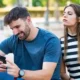 Suspicious woman checking her partner’s phone secretly