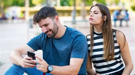 Suspicious woman checking her partner’s phone secretly