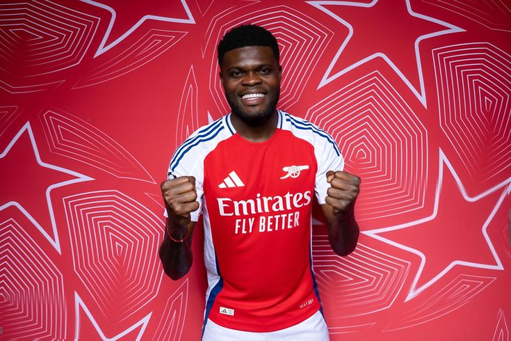 Thomas Partey walking off a football pitch in a serious mood