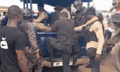 Police officers arrest men posing as fake security personnel near Awoshie polling station