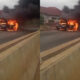 BMW car engulfed in flames on Spintex Road as bystanders watch in shock.