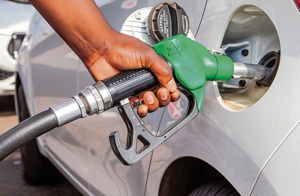 A fuel pump attendant serving customers at a petrol station in Accra, Ghana, where major Oil Marketing Companies have kept pump prices unchanged despite industry projections of marginal adjustments.