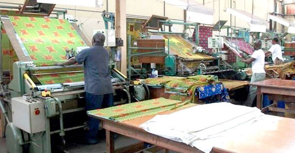 Ghana textile factory with workers and modern garment production equipment