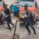 A man angrily walks around his car at a fitting shop, invoking curses after discovering one of his vehicle’s tyres was stolen.