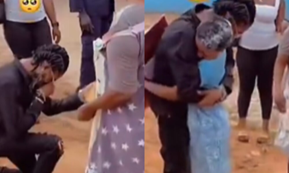 Young man kneels to propose to SHS girl in uniform after WASSCE as crowd cheers.