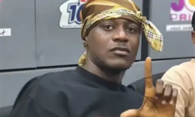 Keche Joshua performing on stage at a music concert in Accra.