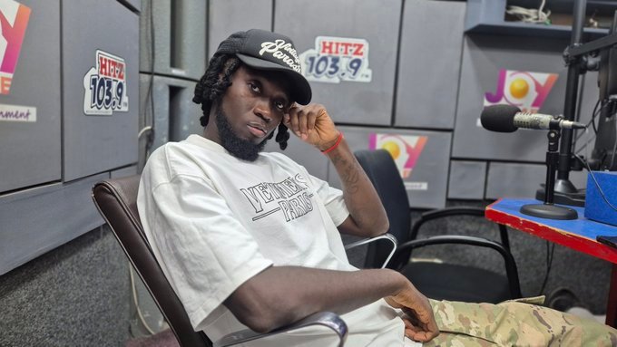 A hype man energizing a crowd at a live music event in Ghana