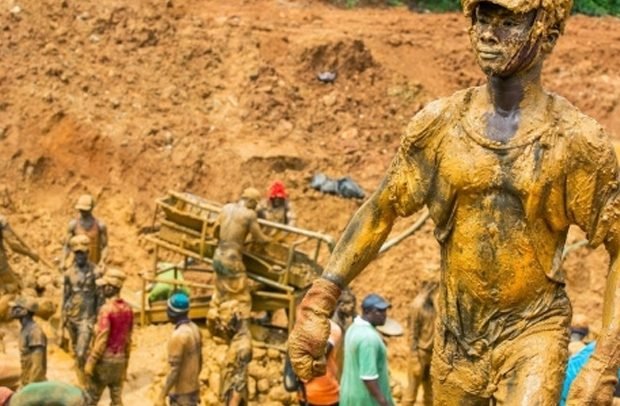 Illegal mining site in Ghana showing polluted water and damaged land