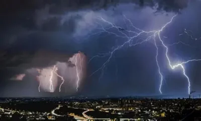 Cloudy sky with approaching thunderstorms over a Ghanaian cityscape.