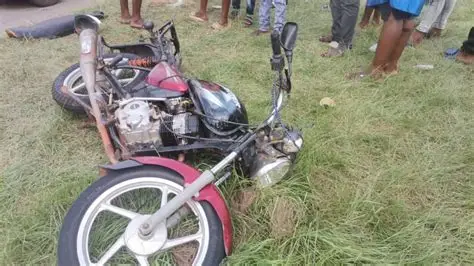 Motorbike riders on a highway in the Bono Region without crash helmets